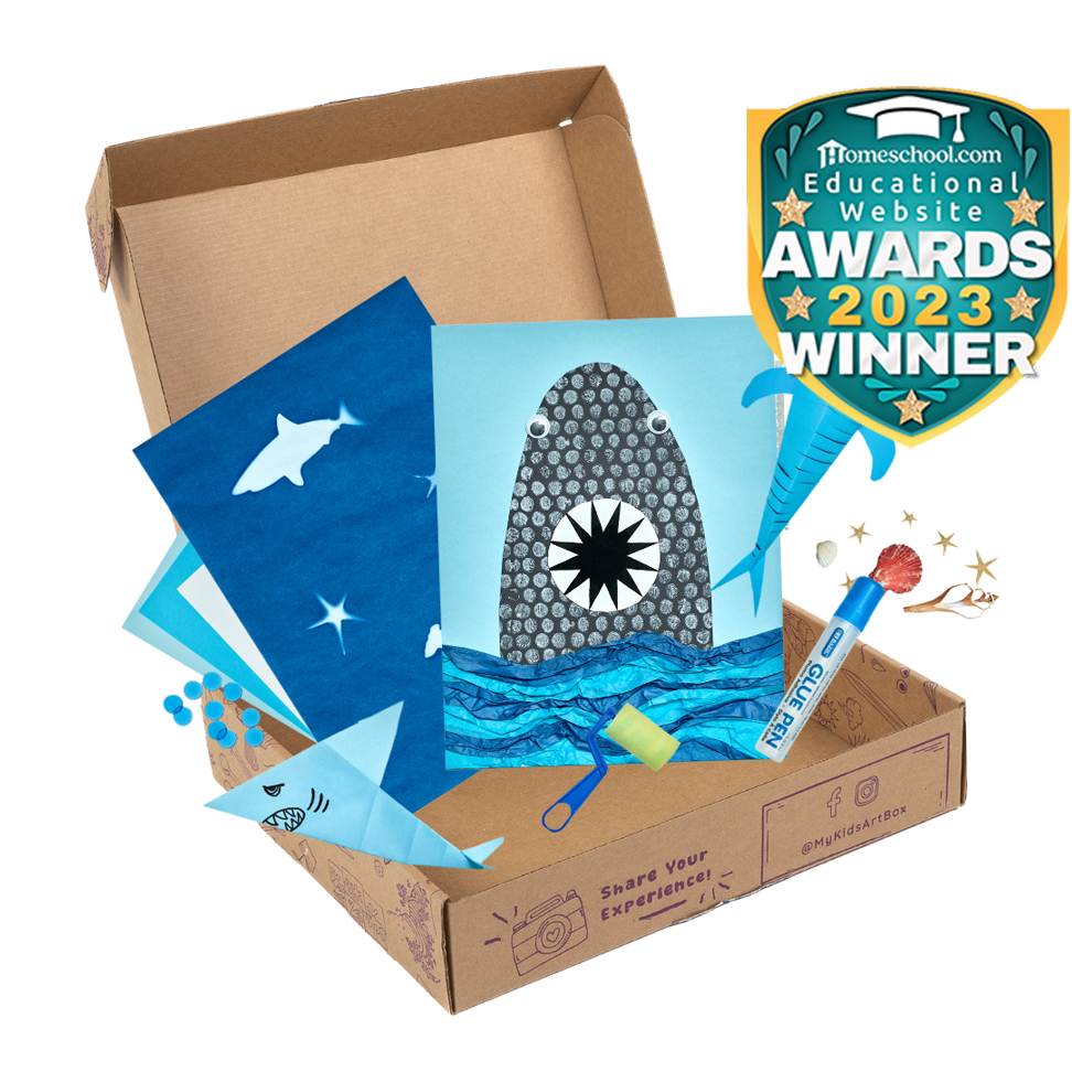 Open craft box with shark-themed project
