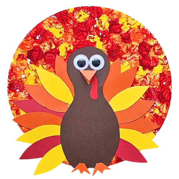 Thanksgiving cork-stamped turkey craft for kids with colorful paper and feathers